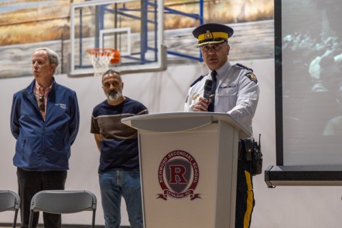 Chief Superintendent addressing students in school gymnasium