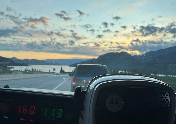 The interior of a BC Highway Patrol cruiser showing a speed reading of 160 km/h for a minivan driven by an unlicenced teenager