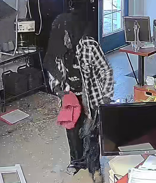 surveillance captured an individual wearing dark clothing, while attempting to cover their face