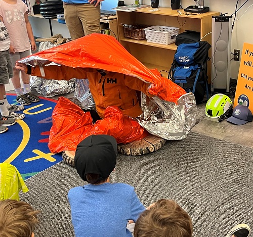 Photograph of the Squamish SAR Prevention Team educating students at a local Elementary school about outdoor safety. 