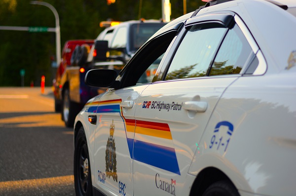 A BC Highway Patrol police car stopped at roadside. There will be no changes to school zone enforcement on July 1, 2025