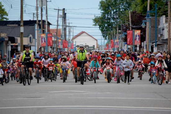 RCMP officers riding in the kid&rsquo;s bike parade in Steveston.