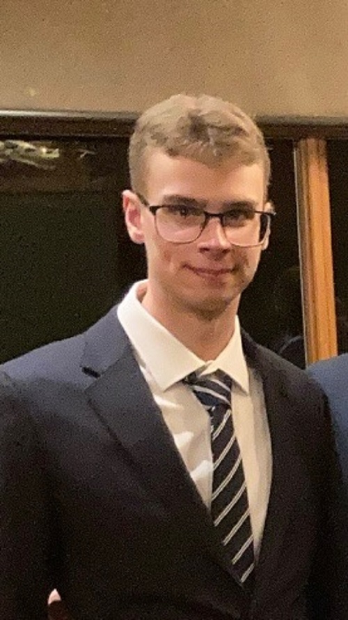 Photograph of Kolton Swift wearing a suit
