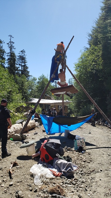 Photo of two individuals on tripod structure