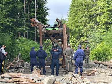 large wooden structure with RCMP members