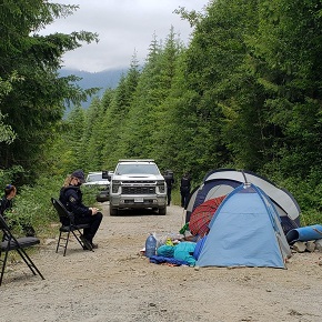 female rcmp member sitting on chair looking at a tent