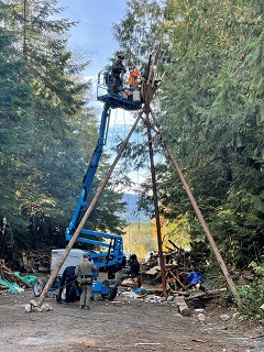 individual being lowerd from tripod structire