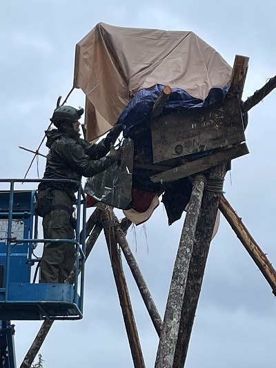 Photo of officer removing individual on a tripod