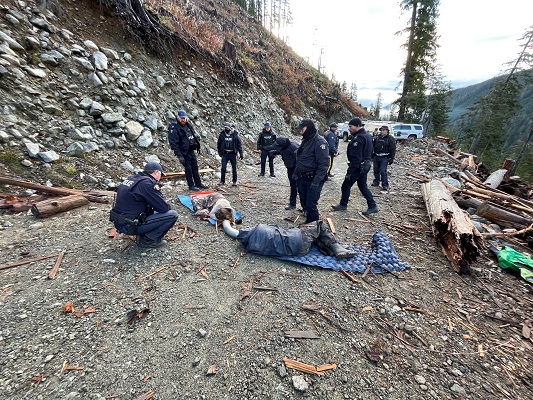 Photo of individuals secured together in a locking device