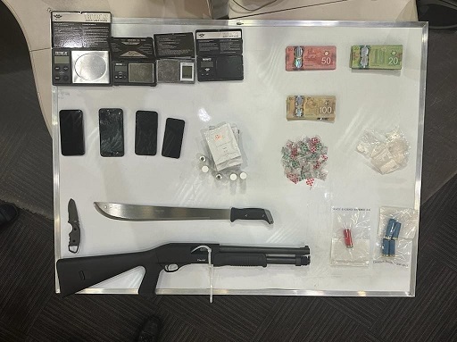 Picture of exhibits seized during the traffic stop which includes drug paraphernalia, cash, weapons, and cell phones, 