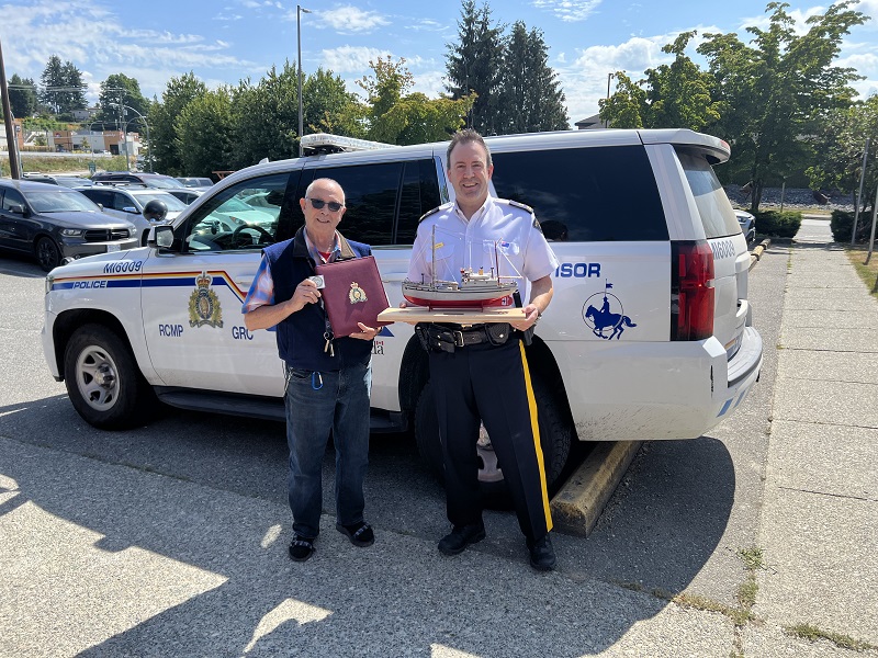 Bruce Smith presenting a model of the St Roch schooner to Inspector Lewko