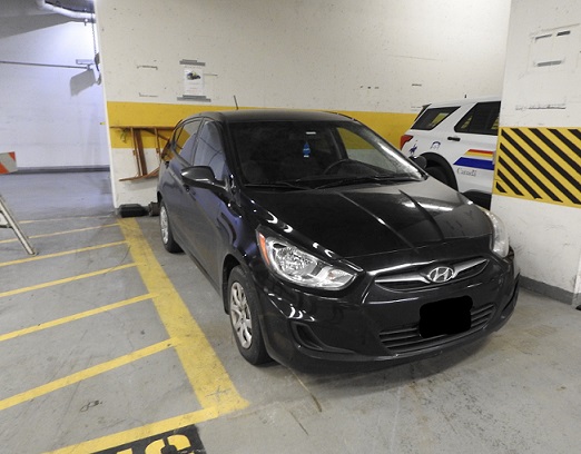 Picture of a black Hyundai hatchback parked in a police parkade