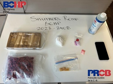Overhead photo of various packages of seized drugs and cellphone