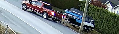 Photo of red truck stealing boat and trailer