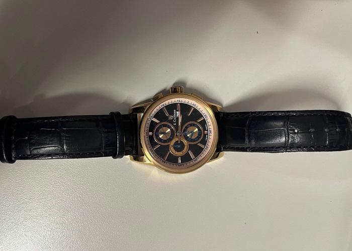 Gold faceplate watch with a black leather band