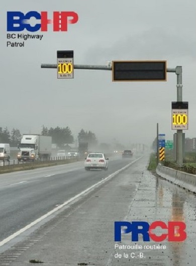 Photo of variable speed limit sign over highway displaying speed of 100 km/h
