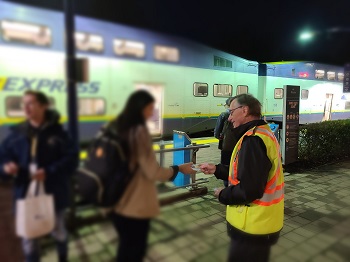 Photo of volunteer handing out safety reflector