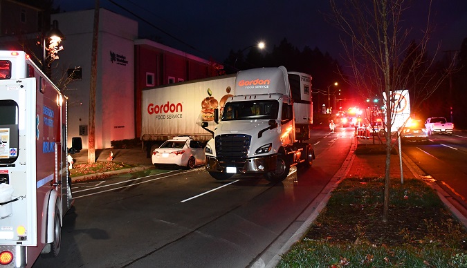 Photo of collision, vehicle trapped under tractor trailer