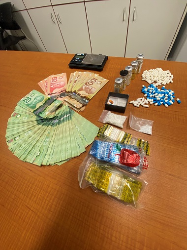 Suspect drugs, cash, paraphernalia   