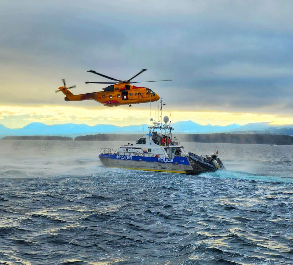 Photo of Inkster and a SAR helicopter.