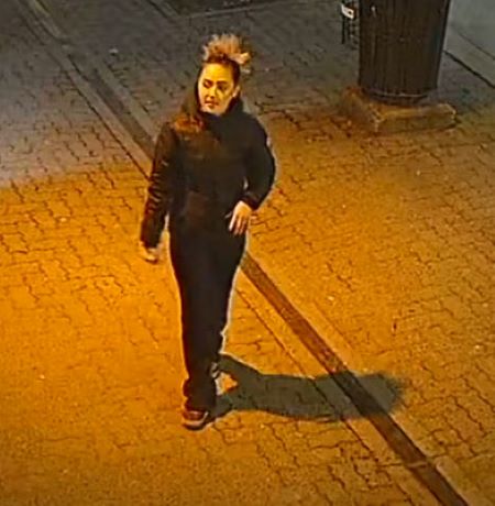 In this image, the woman has tied her hair in a bun.