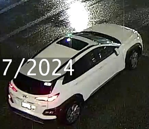 Side profile of the white 4-door Hyundai