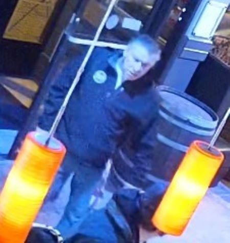 Une vue de face d&rsquo;un homme aux cheveux gris portant un manteau. 