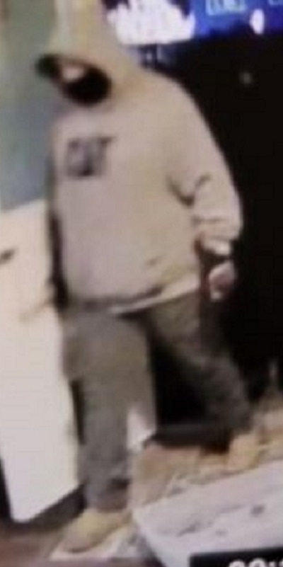 Suspect 1 wearing a black facemask dressed in a grey CAT hoodie and light pants