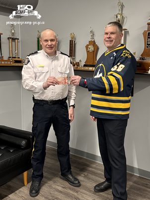 In keeping with tradition, Prince George Fire Chief Warner donned the winning jersey and made a donation of his own toward the RCMP&rsquo;s chosen charity.