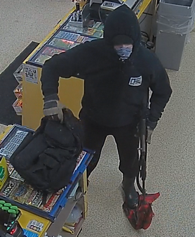 Photo of the suspect, seen wearing a black hoody with a photograph of the McLovin&rsquo; ID on the front, black pants and a black face covering.