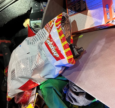 Photo of chip bag with gun inside