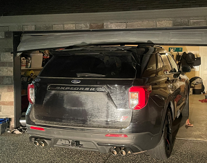 Suspect Ford Explorer stuck under garage door