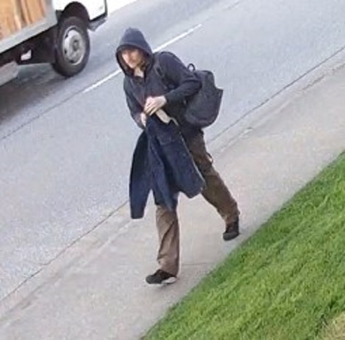 Picture of a man holding a dark blue coat