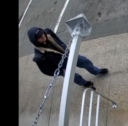 Overhead view of a man walking wearing a blue coat